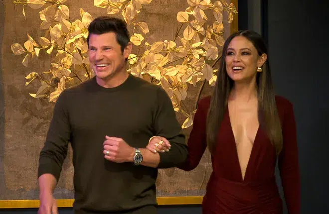 **Alt text:** *Love Is Blind Season 9 hosts walking arm in arm and smiling during a scene from the show.*