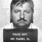 File photo of John Wayne Gacy’s arrest on December 21, 1978. After being convicted of 33 murders, he was executed by lethal injection in 1994. In 1998, investigators revisited a Chicago apartment building once linked to Gacy after new information suggested more possible victims buried nearby.